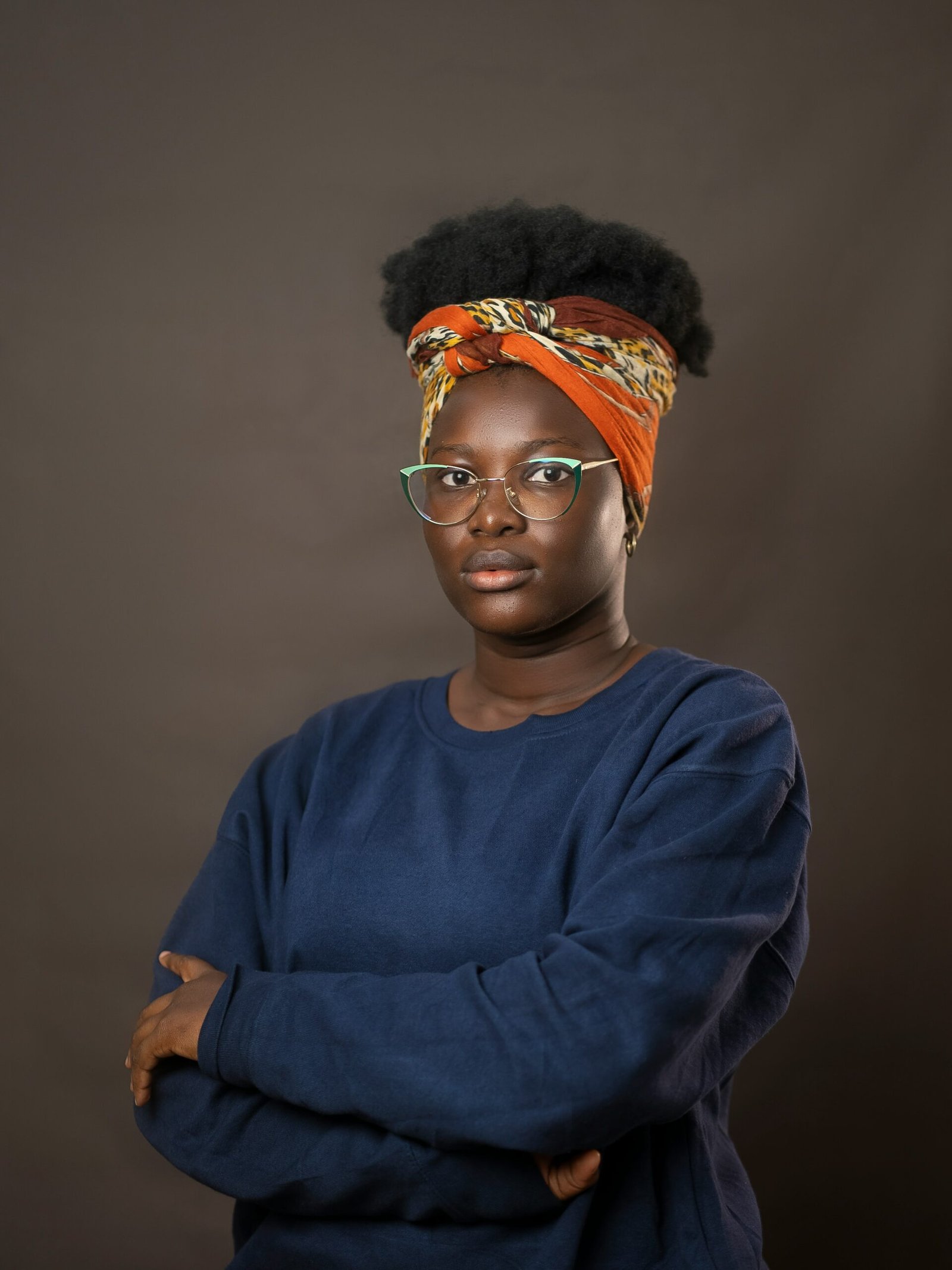 a woman wearing glasses and a head scarf